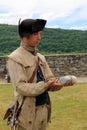 Young man dressed in period costume, demonstrating canon firing, Fort Ticonderoga, New York, 2016 Royalty Free Stock Photo