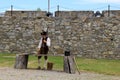 Young man dressed in soldier`s uniform, doing everyday chores, Fort Ticonderoga, NY, 2016