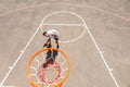 Young Man Dribbling Basketball Below Net on Court Royalty Free Stock Photo