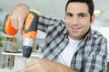 young man drilling hole with impact drill Royalty Free Stock Photo