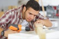young man drilling hole into wood Royalty Free Stock Photo