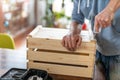 Man drilling wooden crate with power tool at home Royalty Free Stock Photo