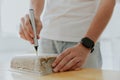 A young man drills a box with a mini drill. Royalty Free Stock Photo