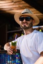 Young man drink cocktail in beach bar Royalty Free Stock Photo
