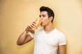 Young man drinking big glass of healthy fruit Royalty Free Stock Photo