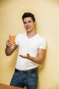 Young man drinking big glass of healthy fruit Royalty Free Stock Photo