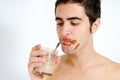 Young man drinking chocolate milkshake