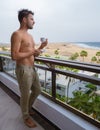 young men drinking coffee on the balcony during vacation in Gran Canaria Spain Royalty Free Stock Photo