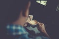 Young man drinking coffee cup in cafe and looking at phone scree Royalty Free Stock Photo