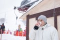 Young man drinking a cup of hot coffee to warm up Royalty Free Stock Photo