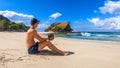 Koka Beach - A young man drinking a fresh coconut on the idyllic beach Royalty Free Stock Photo
