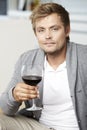 Young man drinking a glass of redwine