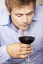 Young man drinking a glass of redwine Royalty Free Stock Photo