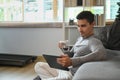 Man drinking hot coffee and reading news on digital tablet in the morning. Royalty Free Stock Photo