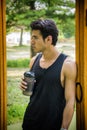 Young man drinking protein shake in outdoor gym Royalty Free Stock Photo