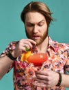 Young man drinking red margarita cocktail drink juice with black straw over blue mint Royalty Free Stock Photo