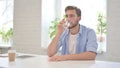 Young Man Drinking Water in Modern Office Royalty Free Stock Photo