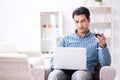 The young man drinking wine at home Royalty Free Stock Photo