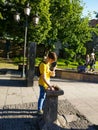 Young man drinks water from a fountain on Tbilisi street