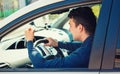 Young man driver yelling and shaking his fist threatens another motorist Royalty Free Stock Photo