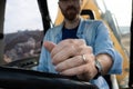 Young man driving a backhoe loader in the countryside Royalty Free Stock Photo