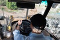Young man driving a backhoe loader in the countryside Royalty Free Stock Photo