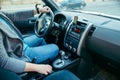 Young man driving car. coffee cup in cup holder Royalty Free Stock Photo