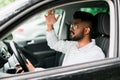 Young man driving a car and looks angry, shouting inside the car Royalty Free Stock Photo