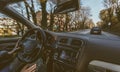 Young man driving a car with one hand. Concentrating and safe driving on the road concept