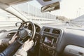 Young man driving a car with one hand. Concentrating and safe driving on the road concept