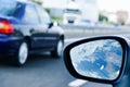 Young man driving a car reflected in the wing mirror Royalty Free Stock Photo