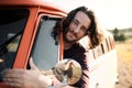 A young man driving a car on a roadtrip through countryside. Royalty Free Stock Photo