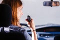 Young man driving car using cb radio Royalty Free Stock Photo