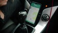 Young man driving a car using navigator on the phone Royalty Free Stock Photo