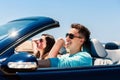 Young man driving with girlfriend in convertible Royalty Free Stock Photo