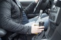 Young man driving his car while drinking alcohol Royalty Free Stock Photo