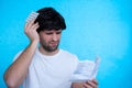 Young man with drugs and pills. Sick man looking at the explanation of the medicine before taking prescription Royalty Free Stock Photo