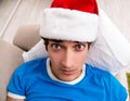 Young man drunk at home after christmas party Royalty Free Stock Photo