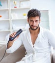 The young man drying hair at home with a hair dryer blower Royalty Free Stock Photo