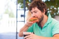 Young man eating burger in restaurant. Royalty Free Stock Photo