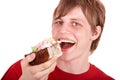 Young man eating chocolate cake. Royalty Free Stock Photo