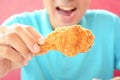 Young man eating deep fried chicken leg or drumstick Royalty Free Stock Photo