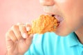 Young man eating deep fried chicken leg or drumstick Royalty Free Stock Photo