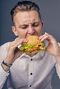 Young man eating a fresh burger