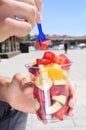 Young man eating a fruit salad outdoors Royalty Free Stock Photo