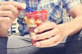 Young man eating a fruit salad outdoors Royalty Free Stock Photo