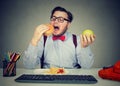 Obese employee eating fast food at workplace Royalty Free Stock Photo