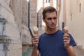 Young man eating ice cream in an alley