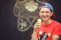 Young man eating ice cream on the street Royalty Free Stock Photo