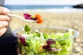 Young man eating a prepared salad outdoors Royalty Free Stock Photo